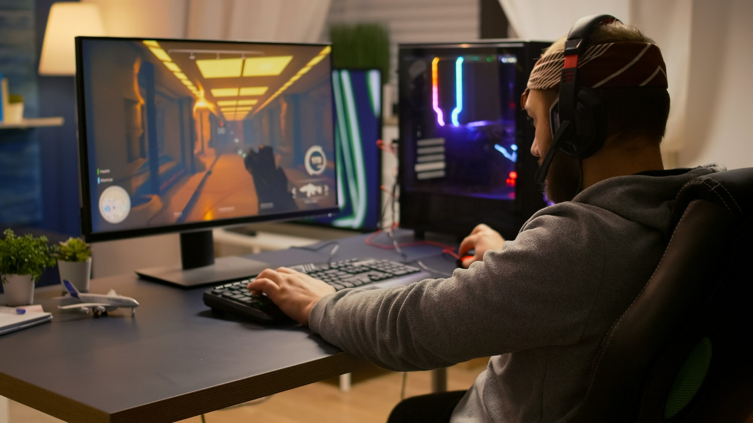 homem sentado em frente a um computador jogando